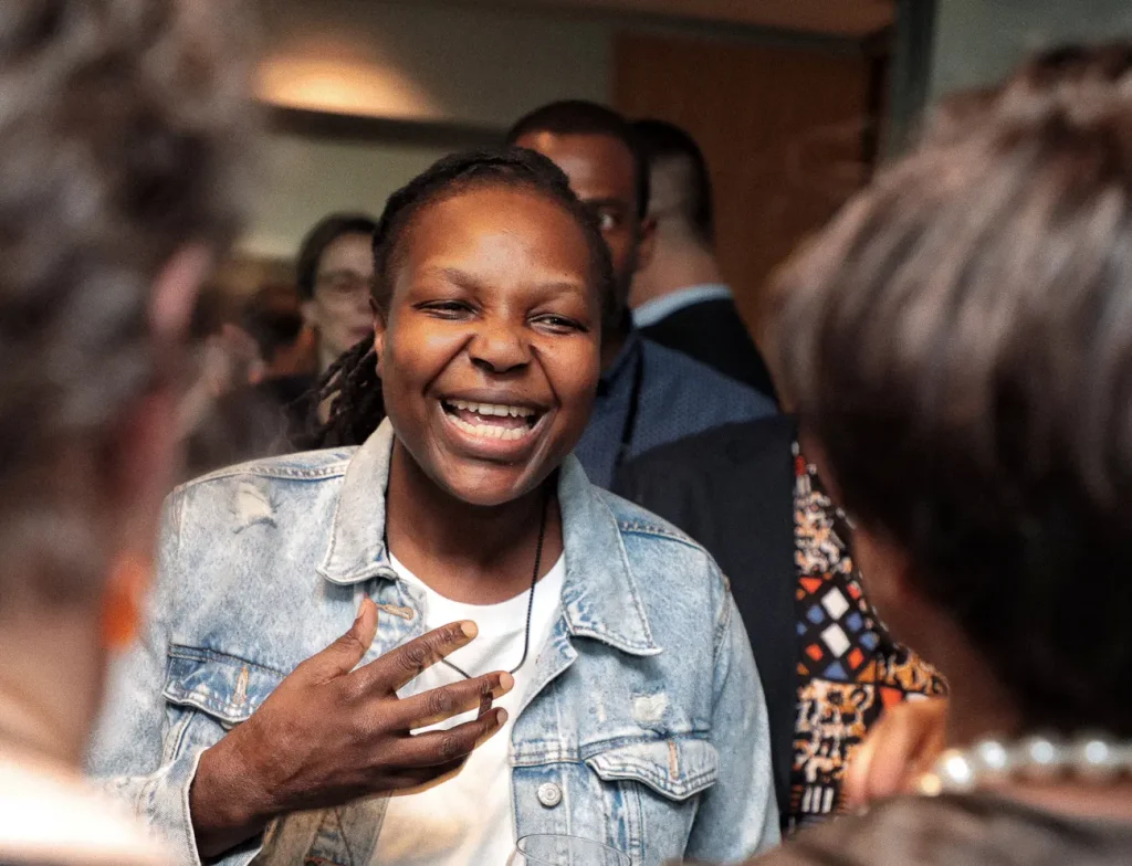 A person gestures and smiles while conversing